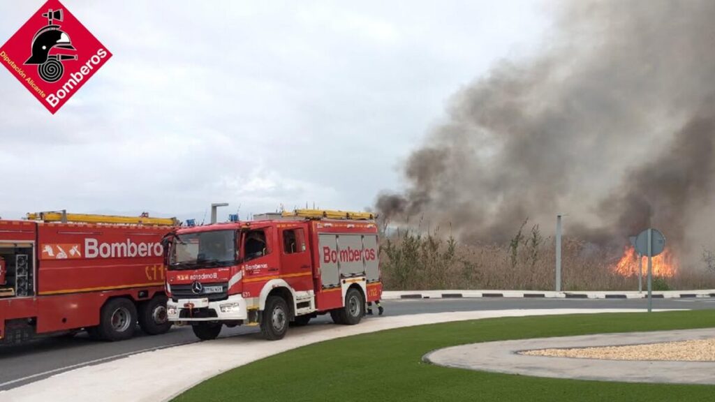 Firefighters extinguishing a vegetation fire in San Fulgencio