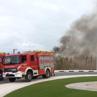 Firefighters extinguishing a vegetation fire in San Fulgencio