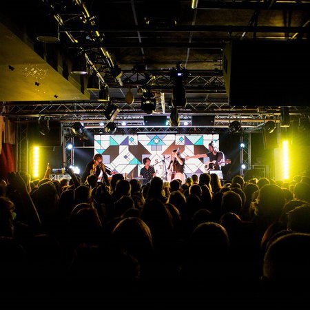 Interior of Sala REM in Murcia with stage lighting and crowd during a live music night