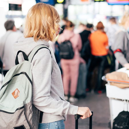 Travellers walking through a busy airport terminal during Easter holiday travel season