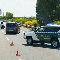 Guardia Civil vehicles driving through traffic on a Spanish motorway during Easter