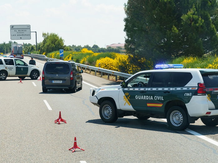 Guardia Civil vehicles driving through traffic on a Spanish motorway during Easter