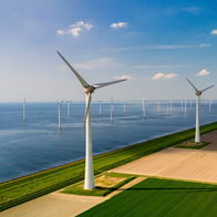 A massive floating wind turbine anchored in deep, rough ocean waters during testing.