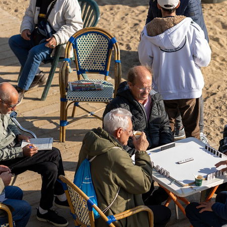 People sitting on a sunny terrace in Spain during unusually warm February weather