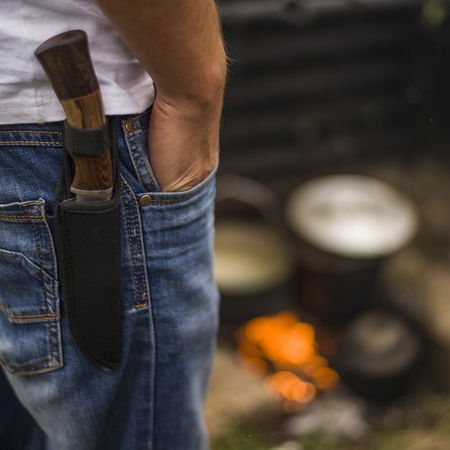 Man cutting wild asparagus with a knife in Mediterranean scrubland in Spain