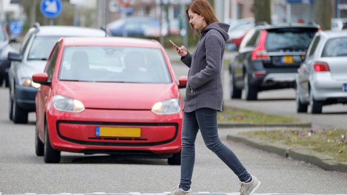 Crossing while gawping at phone.