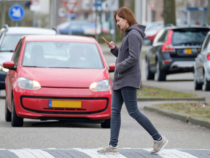 Crossing while gawping at phone.