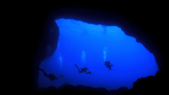 Divers in an underwater cave