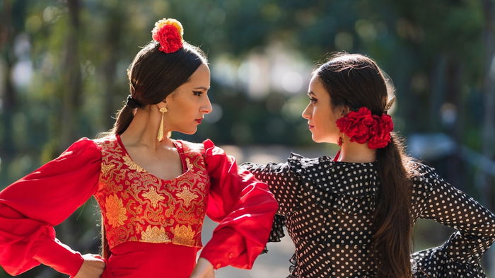 Two flamenco dancers in traditional flamenco dress