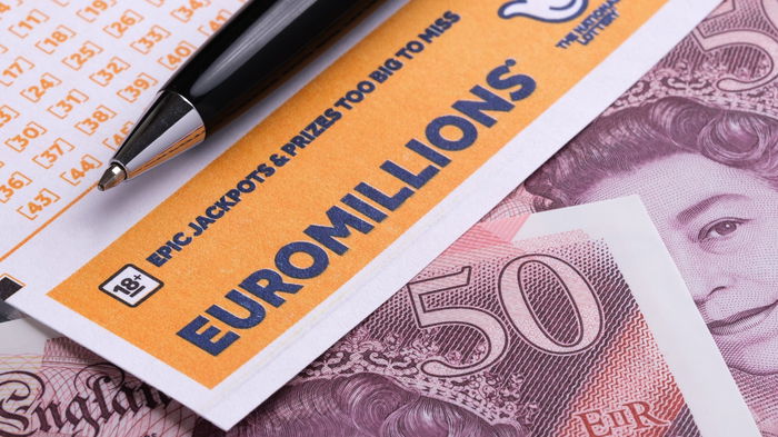 Euromillion ticket with bank notes under it