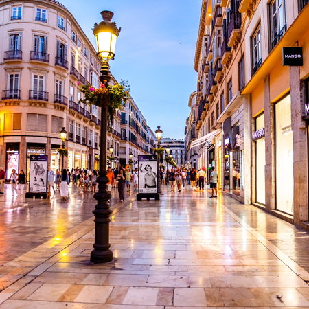 Alarm clock in a spring flower field symbolising Spain’s daylight saving time change.