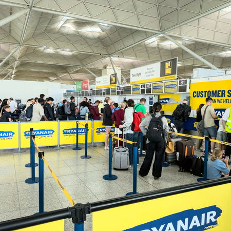 People queuing at baggage control in an airport