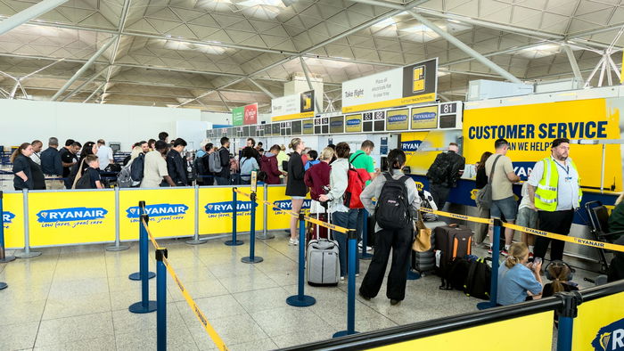 People queuing at baggage control in an airport