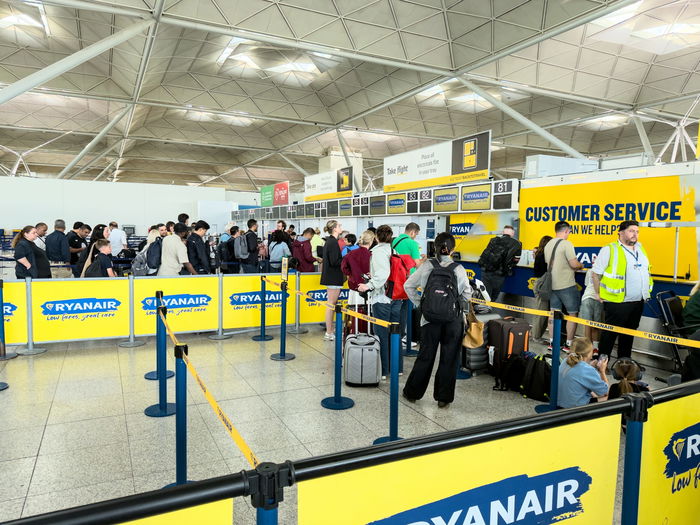 People queuing at baggage control in an airport