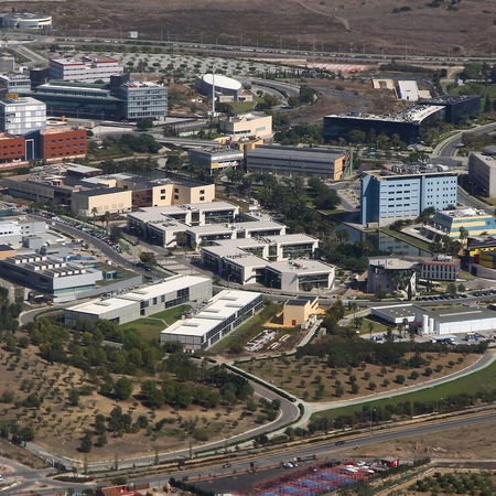 Woman sitting crossed legged with a laptop on her lap