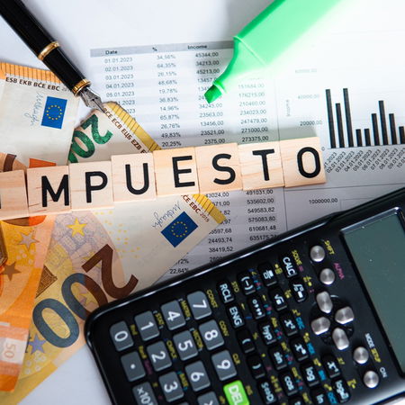 Spanish tax documents, euro banknotes and calculator representing the 2026 tax return process in Spain.