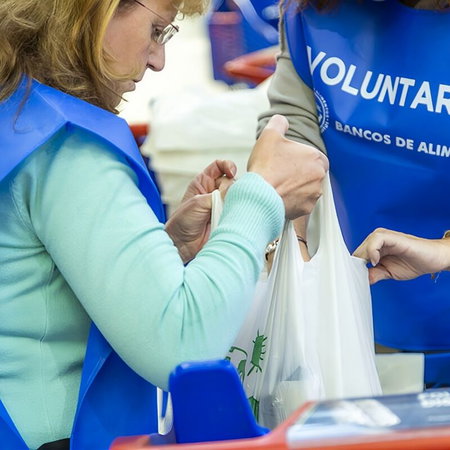 Semana Santa procession at night in Andalucía with penitents in traditional robes and candles