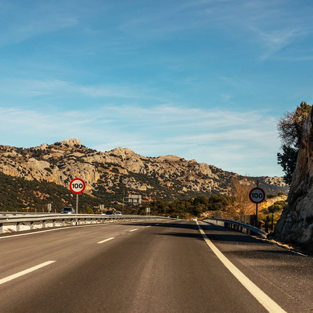 100 kmh speed limit signs on a Spanish motorway through a mountainous area