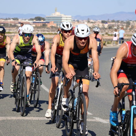 Digital nomad working remotely on a laptop by the sea in Spain