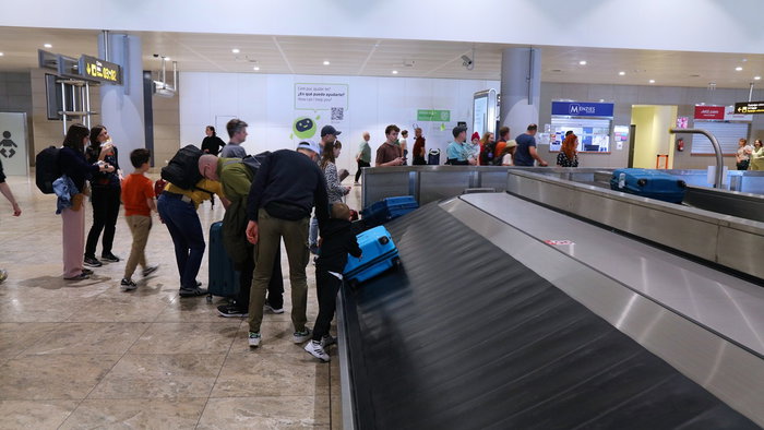 Passengers collecting luggage inside Alicante Airport as new fast track check-in service is expected before summer