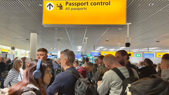 Crowded passport control queue at European airport after new border system