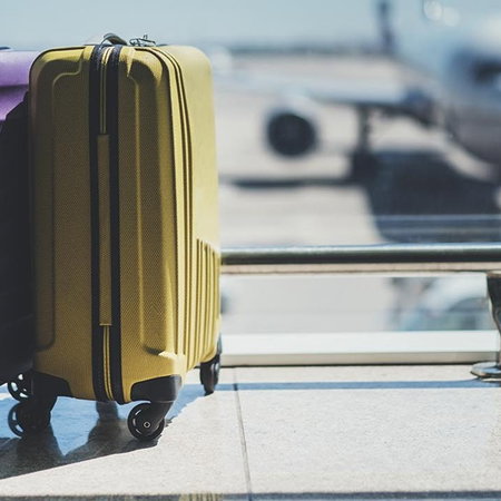 Two cabin suitcases at an airport terminal as Brussels Airlines ends free hand luggage on cheapest fares