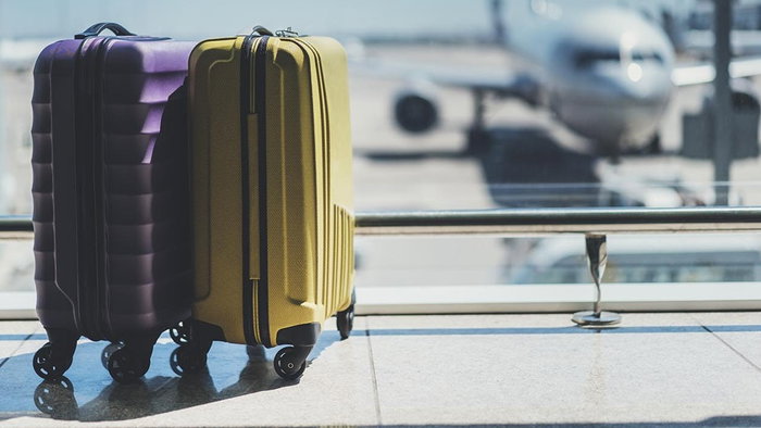 Two cabin suitcases at an airport terminal as Brussels Airlines ends free hand luggage on cheapest fares