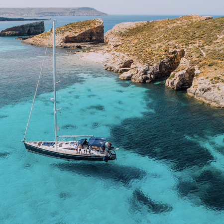 Aerial of Yacht in Blue Lagoon, off Comino