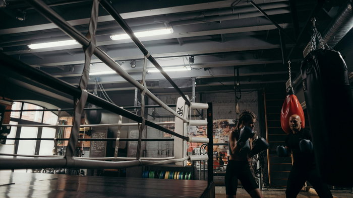 oung woman training at a boxing club using the bag