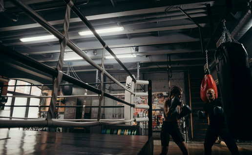 oung woman training at a boxing club using the bag