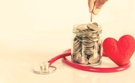 A jar with money in with someone adding to it and a red stethoscope around the bottom of the jar