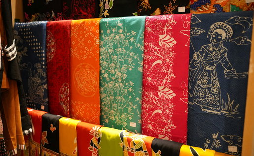 Selection of colourful towels haning on a wall