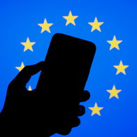 Smartphone silhouette in front of European Union flag representing new EU phone rules