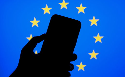 Smartphone silhouette in front of European Union flag representing new EU phone rules