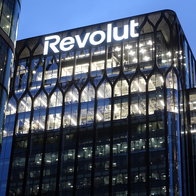 Revolut headquarters building illuminated at night, highlighting the fintech brand’s expansion