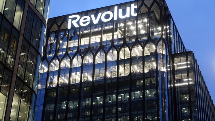 Revolut headquarters building illuminated at night, highlighting the fintech brand’s expansion