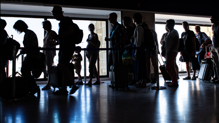 People in a queue for passport control at an airport
