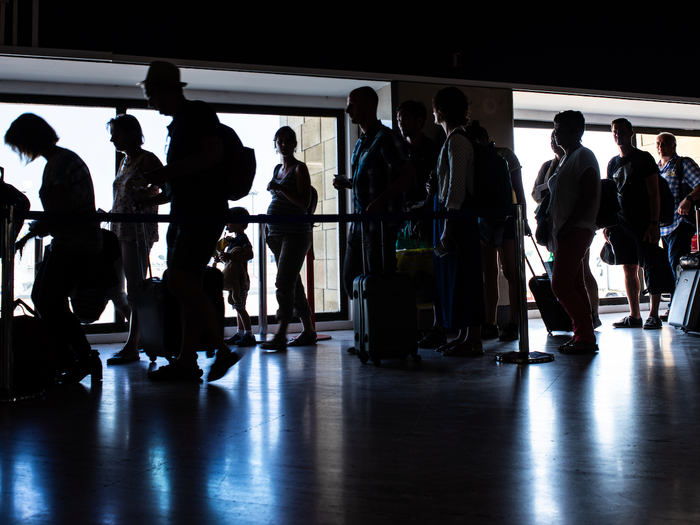 People in a queue for passport control at an airport