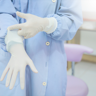 Person putting sterile gloves on