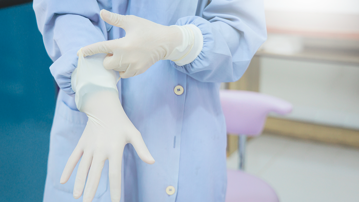 Person putting sterile gloves on