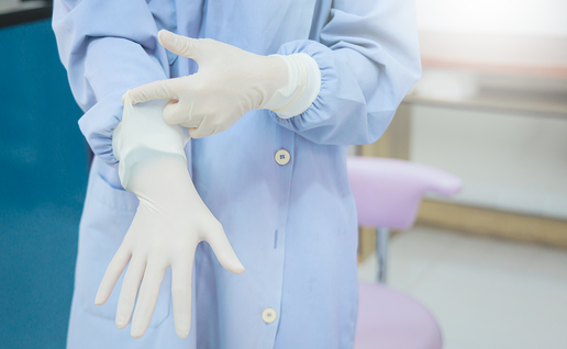 Person putting sterile gloves on