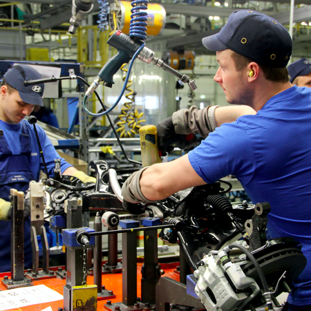 Men working in a car factory