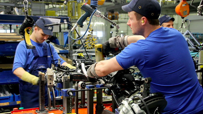 Men working in a car factory