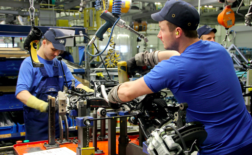 Men working in a car factory
