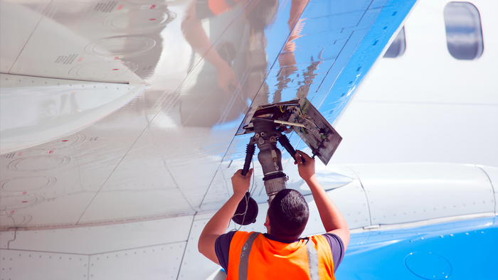 Man putting fuel into an aircraft