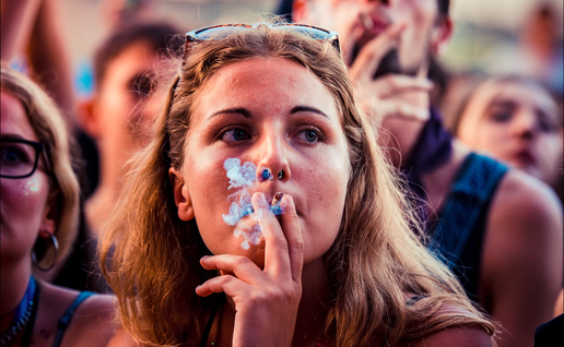 Young woman smoking a cigarette at a festival