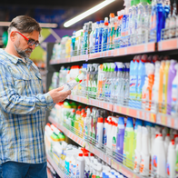 Man in a supermarket looking at cleaning products