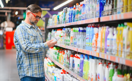 Man in a supermarket looking at cleaning products