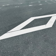 White diamond road marking on a Spanish motorway lane used for BUS VAO high occupancy traffic