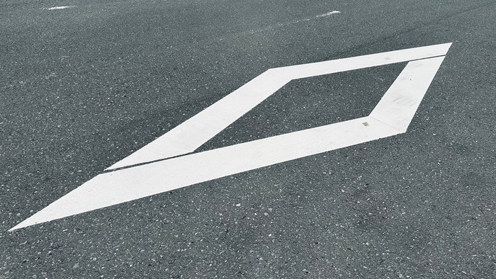 White diamond road marking on a Spanish motorway lane used for BUS VAO high occupancy traffic